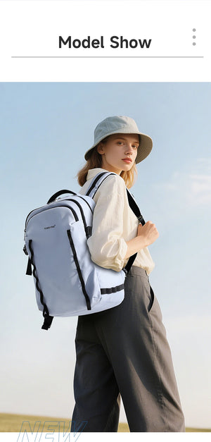 Light blue waterproof travel backpack worn by a model, with two front zip pockets