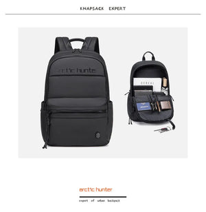 Black backpack with multiple pockets and compartments on a white background, featuring the brand 'Arctic Hunter'.