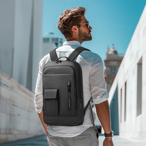 Black compact backpack worn with adjustable shoulder straps and front pocket