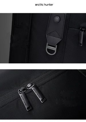 Black duffle bag close-up of zipper pulls and branded fabric webbing strap