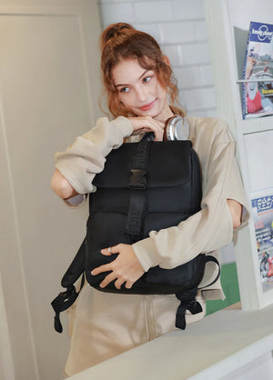 Black compact waterproof commuter backpack with front buckle straps and zip pockets