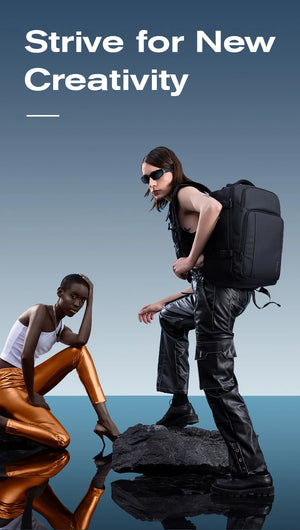 Black travel backpack worn by people, with padded straps and front buckle detail visible.