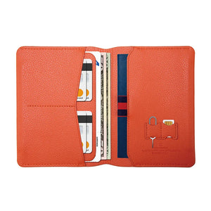 Orange leather passport wallet opened, card slots and passport compartment with embossed icons