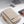 Beige laptop bag with brown side accents and zip front, compact design