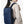 Blue compact waterproof backpack side view with front zipper and shoulder straps