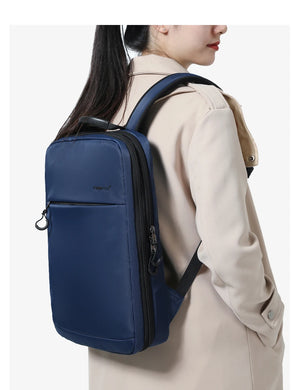 Blue compact waterproof backpack side view with front zipper and shoulder straps