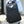 Grey backpack worn by a person with front organizer pocket and top handle