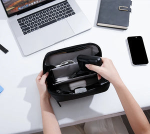 Open black tech storage bag with compartments for devices and accessories