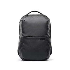 Black compact laptop backpack with curved top handle and front zip pocket
