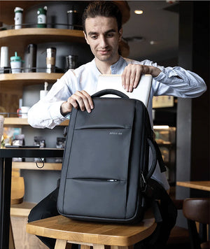 Waterproof travel backpack, dark gray front panel with top carry handle and zipper pocket
