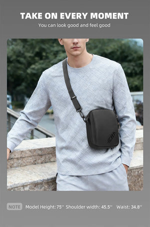 Black crossbody messenger bag worn on chest with adjustable shoulder strap
