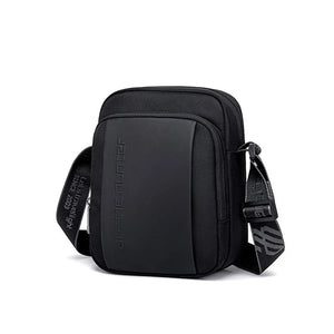 Black compact waterproof messenger bag with curved top and front zip compartment