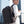 Black expandable waterproof backpack on person, side profile with adjustable straps