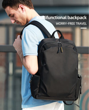 Black backpack worn on shoulders with front zipper pocket and side hanging strap