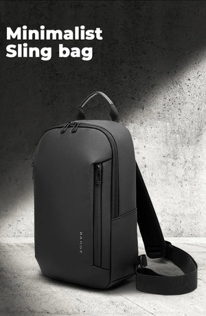 Minimalist sling bag in dark gray with top handle and shoulder strap, front zipper panel.