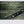 Green waterproof fabric with water droplets and sealed zipper detail