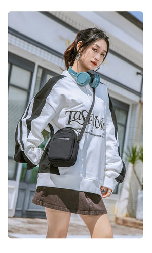 Compact waterproof crossbody bag in black worn crossbody with strap
