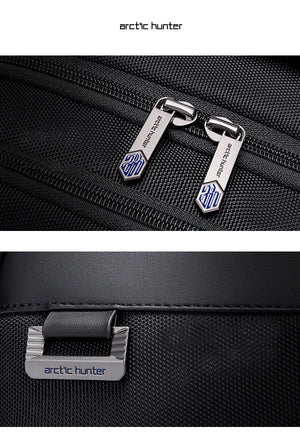 Black waterproof travel backpack close-up of zipper pulls and branded metal label