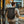 Black roll-top backpack worn on back with top handle and adjustable shoulder straps