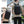 Black travel backpack worn by a person, with padded back and adjustable straps