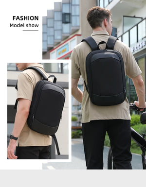 Black travel backpack worn by a person, with padded back and adjustable straps