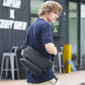 Black crossbody bag worn cross-body with adjustable strap and front flap