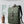Green backpack with external double side pockets, front flap, and carry handle