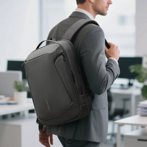 Black travel backpack worn at the side view with zip pocket and padded shoulder strap