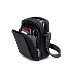 Black compact messenger bag open with multiple internal compartments and zip closures