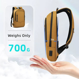 Yellow compact waterproof backpack with top handle, front zip pocket, and side straps