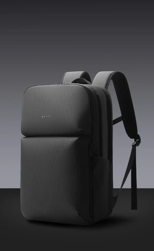 Dark gray water-resistant travel backpack with padded top and side straps