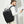 Black travel backpack worn on the back with padded shoulder straps and top handle