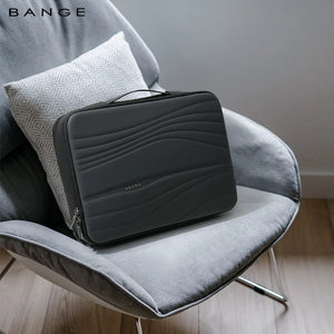 Black laptop sleeve with quilted wave panel, zipper, and carry handle on seat