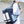 Blue and navy travel backpack on person, featuring front compartments and padded straps