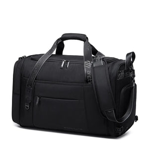 Black waterproof duffel bag with side straps, front zip panel, and adjustable shoulder strap.
