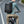 Black waterproof travel backpack on bicycle rider, front pocket and adjustable straps