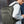 Green backpack worn on the back with padded shoulder straps and front pockets