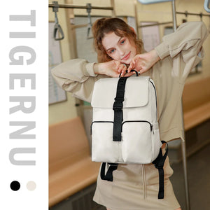 Beige compact commuter backpack with black front flap, zip pockets, and adjustable shoulder straps