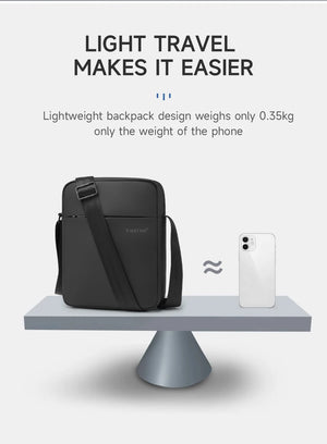 Black lightweight crossbody bag with smooth shell and wide crossbody strap.