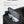 Black duffle bag with mesh wet/dry compartment holding bottles and toiletries
