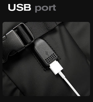 Black backpack USB port on inner strap with charging cable connected