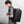 Men's large travel backpack worn, black top flap with front zipper pocket