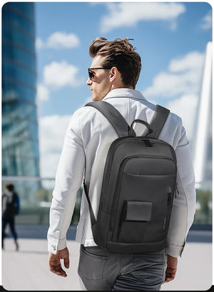 Black compact backpack worn with front panel pocket and adjustable shoulder straps
