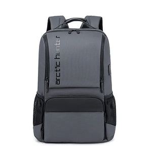Grey waterproof travel backpack with front pocket and adjustable shoulder straps