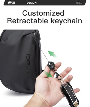 Black crossbody sling bag with retractable keychain detail and front zipper pocket.