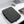 Black padded laptop sleeve on desk with zipper and quilted wave texture