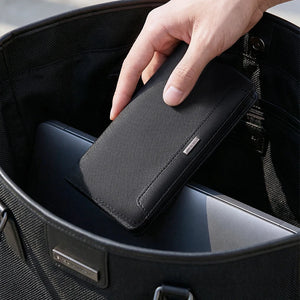 Black bifold wallet open with card slots and checkbook-sized compartment.
