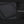 Black crossbody bag feature: tie-rod fastening strap on textured fabric panel.