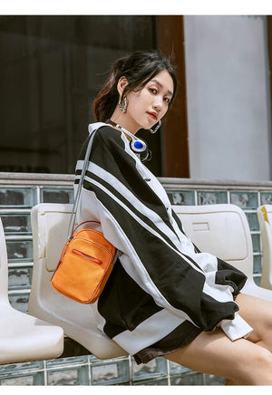 Lightweight waterproof crossbody bag in orange with adjustable shoulder strap