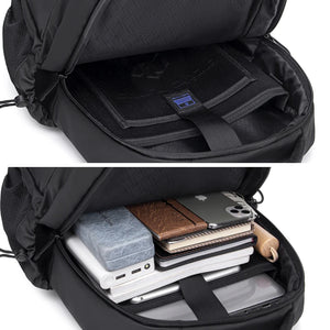 Black travel backpack open to reveal interior compartments for devices and notebooks